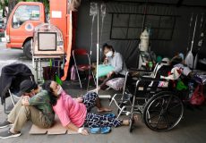 A patient rests on the floor at a temporary tent outside the emergency ward of a government hospital, amid the coronavirus disease (COVID-19) pandemic in Bekasi, on the outskirts of Jakarta, Indonesia, June 25, 2021. REUTERS/Willy Kurniawan
